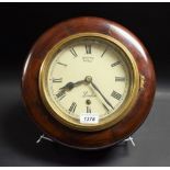 A circular mahogany wall clock,