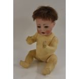 A German bisque shoulder head doll, with sleeping blue eyes, open mouth with two upper teeth,