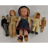 A mid 20th century Googly Eyed Celluloid doll,m wearing a felt headress and smock, white chaps,