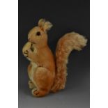 Steiff Toys - a mid 20th century stuffed toy, Squirrel Eating a Nut, button to ear, 21cm high, c.