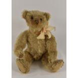 Steiff - an early 20th century bear, black ball button eyes, stitched nose, slight hump back,