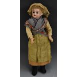 A late 19th century bisque socket head doll, brown eyes, open mouth, curly light brown/blond hair,