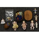 Dolls - a 19th century pottery suspension doll, painted features, yellow dress, green curtains,