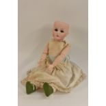 A Kammer & Reinhardt bisque head doll, with open blue eyes, closed mouth, incised K star R,