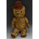 A mid 20th century brown plush musical Teddy Bear, glass eyes, stitched nose, centre seam,
