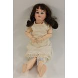 An Armand Marseilles bisque head doll, with sleeping blue eyes, open mouth, brown wig,