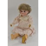 A Simon and Halbig bisque head doll, with sleeping blue eyes, open mouth, four upper teeth,