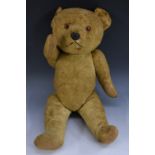 A mid 20th century clockwork musical Teddy Bear, glass eyes, moulded rubber nose,