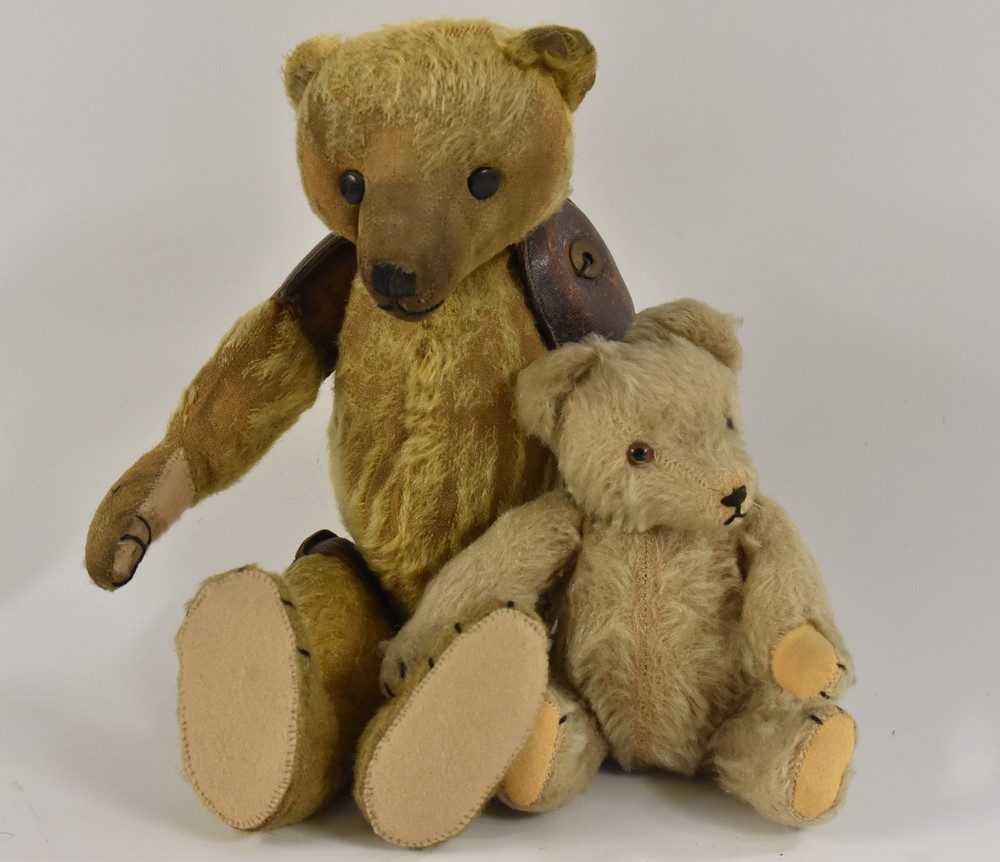 An early 20th century gold plush humpback Teddy Bear, unusual leather capped joints,