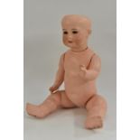 A Carl Harmus bisque head doll, with sleeping blue eyes, open mouth, two upper teeth, blond wig,