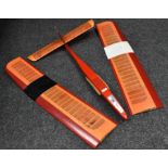 A Radio controlled hand made Glider, sleek red body, two tone red and orange wings,