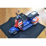 A reproduction tinplate Union Jack scooter