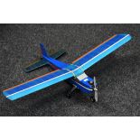 A Radio controlled balsa wood and paper single wing Airplane, blue fuselage,