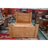 A designer hardwood bed 199cm long,