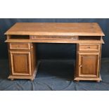A reproduction oak twin pedestal desk