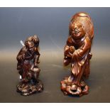 A late 19th century Chinese hardwood carving, of Liu Haichan, the Immortal, holding a stylized toad,