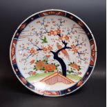 A 19th century style Japanese charger, decorated with a blossoming tree,