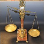A mid 20th century set of brass and marble effect balance scales with weights,