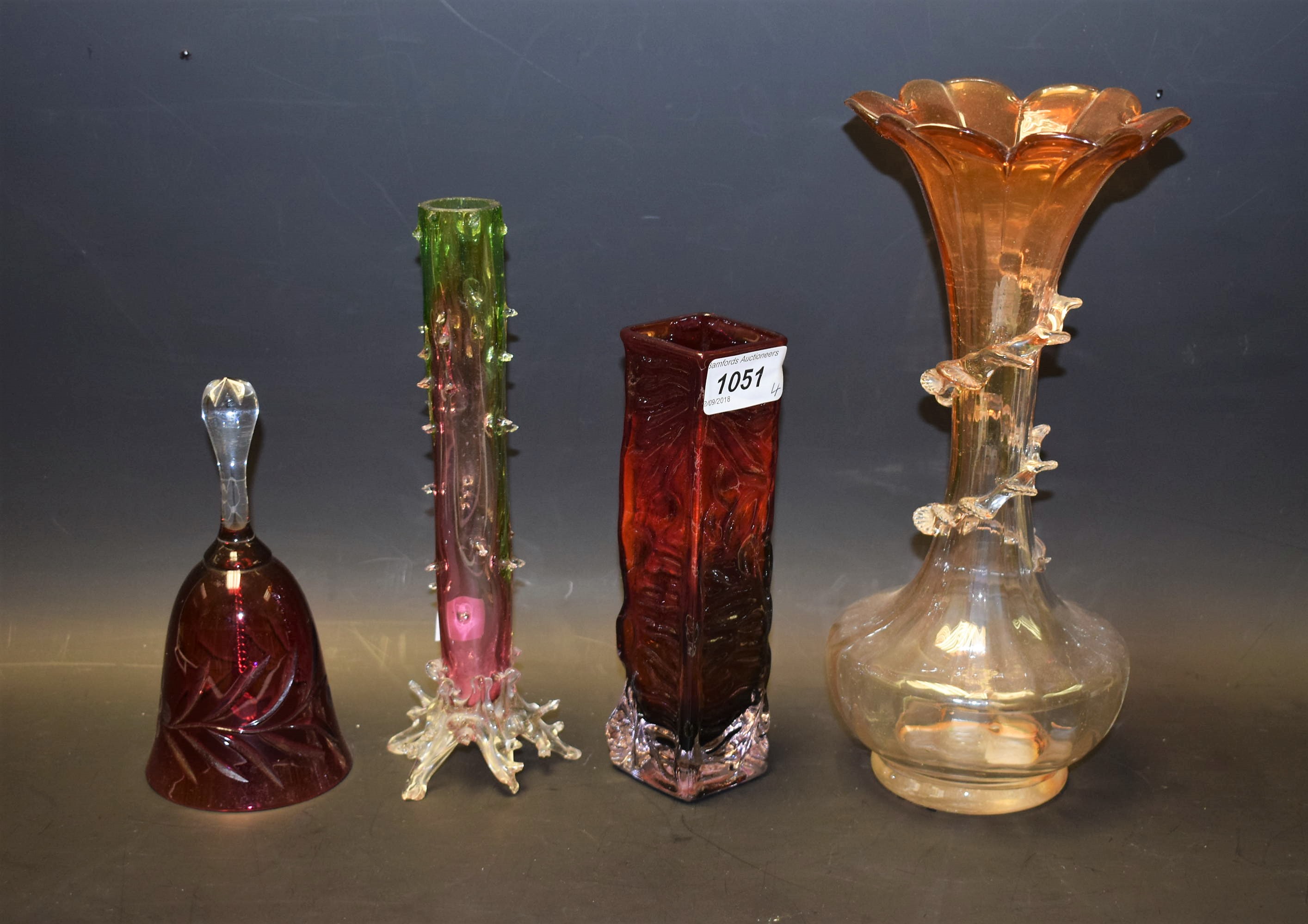 A late 19th century glass vase, a similar bud vase, a 1970's red glass vase,