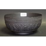 A late 19th century Wedgwood Dancing Hours black basalt bowl, moulded with a band of dancing muses,