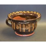A 19th century style terracotta slipware decorated chamber pot