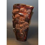 A resin libation cup, decorated with figures in a mountainous landscape,