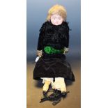 A painted composite and wax shoulder doll, solid cast head with wax covering,