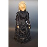 A reproduction late 19th century wax head style doll, of Queen Victoria, in mourning dress,