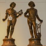 A pair of 19th century French patinated spelter figures, each holding the tools of their trade,