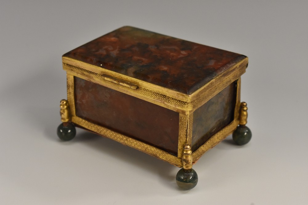 A 19th century agate rectangular miniature casket, hinged cover, gilt metal mounts, ball feet,