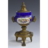 A 19th century ormolu and porcelain mantel urn and cover,