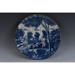 An 18th century Delft circular dish, painted in tones of blue with a stag hunt, 30.