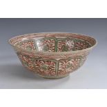 A Middle Eastern flared circular bowl, painted in the Islamic taste with flowers and leafy stems,