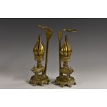 A pair of Indian brass lotus censers, each as a cobra grasping a ring, above a sacred cow,