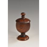 Treen - a 19th century turned pedestal cup and cover, knop finial, domed foot,