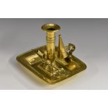 A George III sheet brass chamberstick, dished rounded rectangular base, 18cm wide,