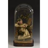 A large 19th century wax diorama, the doll arranged in a mossy woodland setting,marquetry plinth,