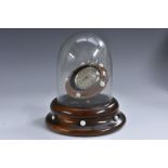 A 19th century walnut pocket watch dome, hinged cover enclosing a posted stand, spreading base,