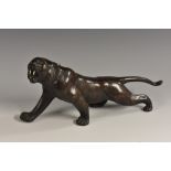 Japanese School (Meiji period), a two-tone brown patinated bronze, of a tiger, prowling,