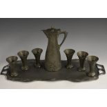 A German Art Nouveau eight-piece pewter service, comprising covered ewer, beakers and a shaped tray,