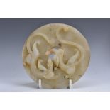 A Chinese jade bi disc, carved in the Archaic taste with stylized beasts,