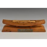 A mid-20th century hardwood desk model, of a canoe,