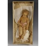 A 19th century wax infant doll or creche figure, blond hair, painted features, 23.5cm long, c.