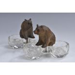 A pair of Black Forest mounted salts, each glass twin-compartment cellar crested by a bear,