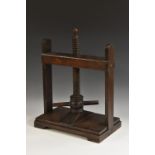 A 19th century oak table top book press, of typical form, turned handle, 53cm high,