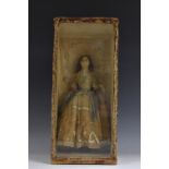 A 19th century wax doll, she stands, wearing a silk trimmed lace dress and holding a book,