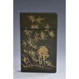 A Japanese lacquer rectangular visiting card case, decorated in gilt with a deer amongst bamboo,