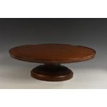 A large 19th century mahogany lazy susan, shallow border, turned base,