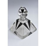 An Art Deco pyramidical perfume bottle, etched, faceted and overlaid in black with geometric motifs,