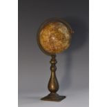 A 19th century terrestrial globe, of small proportions, the paper gores laid on a solid wood core,